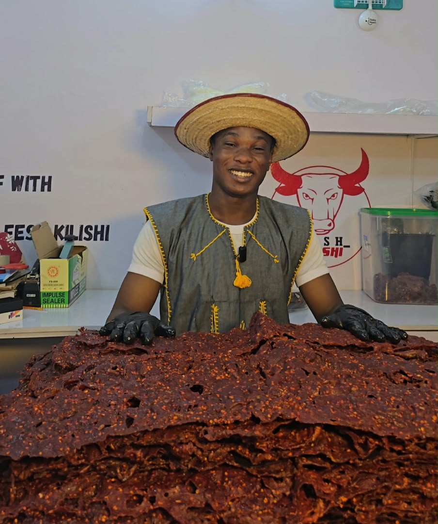Founder Feshitan with a massive stack of authentic Northern Kilishi sheets in Nigeria